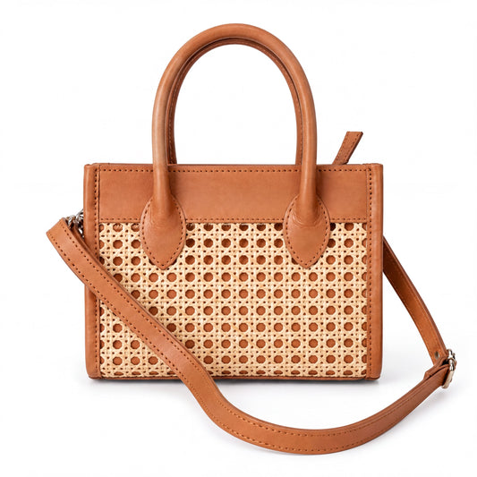 A tan-colored handbag with a woven pattern on the front and a leather strap.