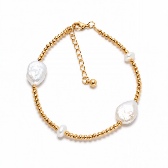 A gold-colored bracelet with three white pearls and three gold beads.