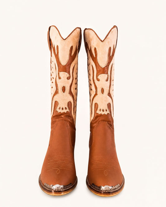 A pair of brown cowboy boots with decorative designs on the sides.