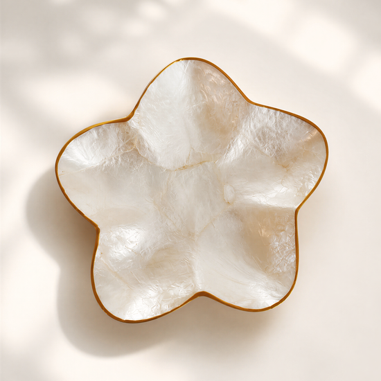 A white ceramic bowl with a gold rim, placed on a white background.