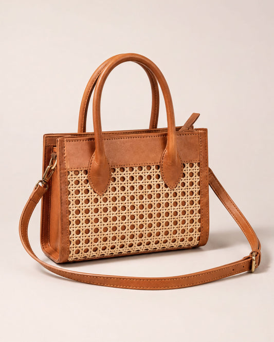 A brown leather handbag with a woven pattern on the front.