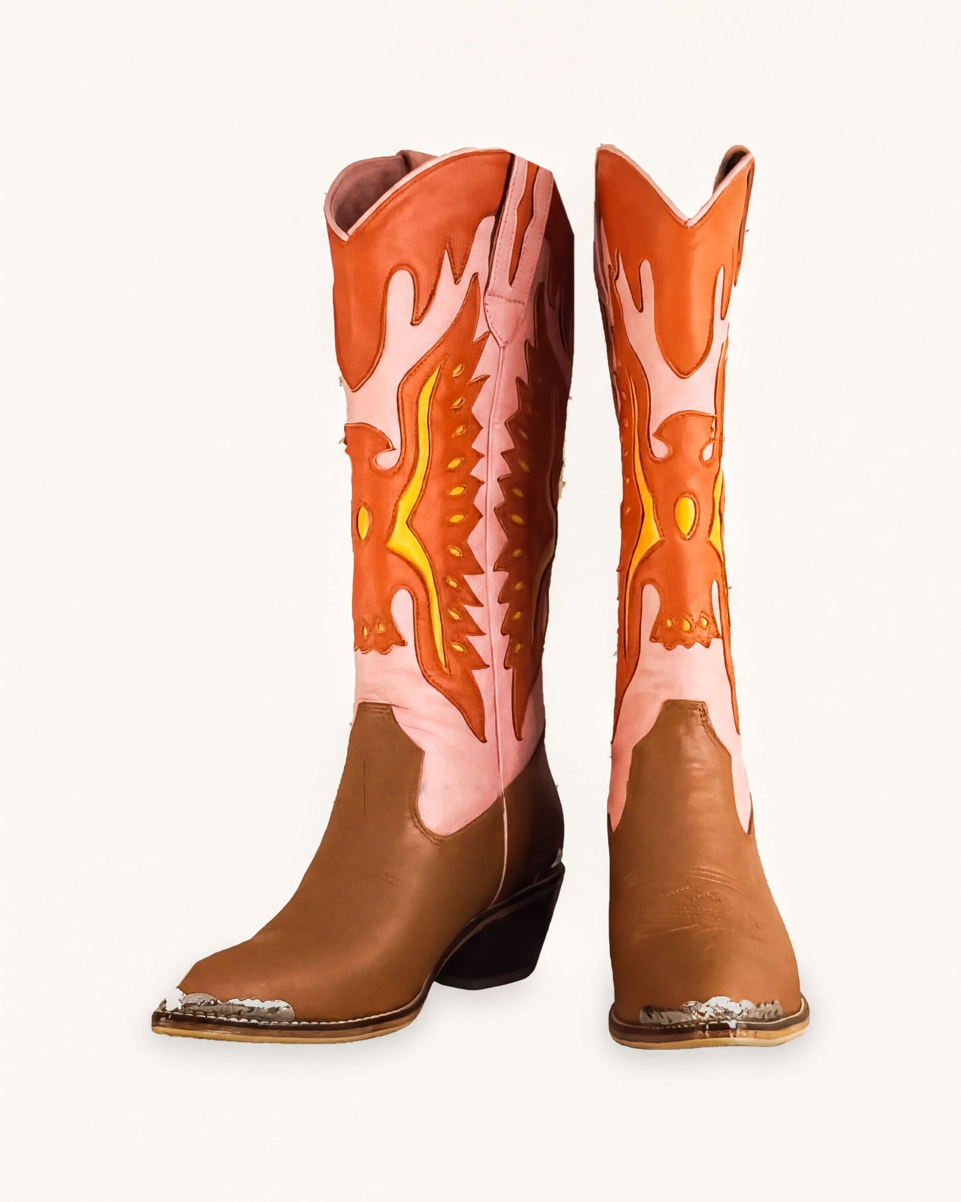 A pair of brown cowboy boots with orange and pink accents, featuring a flame-like design on the sides.