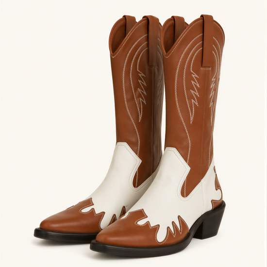 A pair of brown and white cowboy boots against a white background.