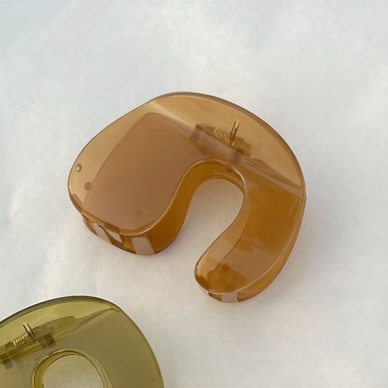 a pair of brown hair clips on a white background.