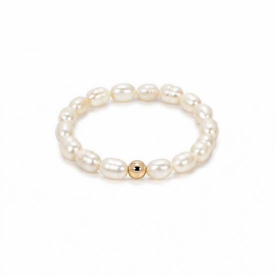 A bracelet made of white pearls and a single gold-colored bead.