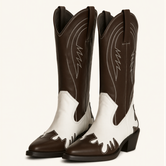 A pair of brown and white cowboy boots against a white background.