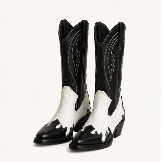 A pair of black and white cowboy boots against a white background.