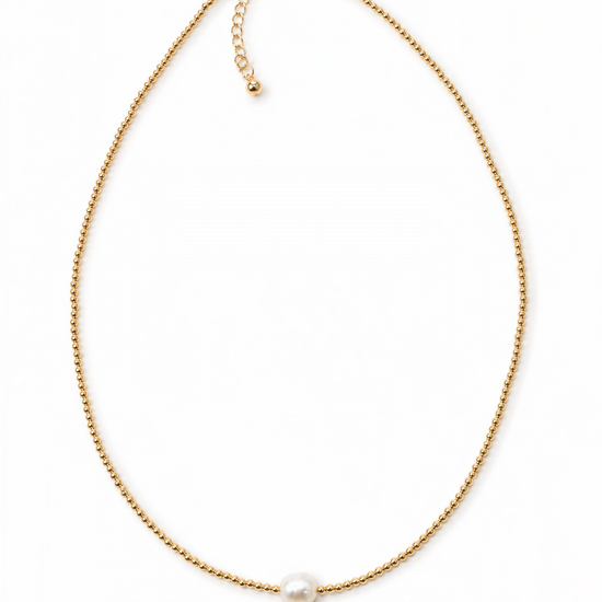 A delicate gold necklace with a single pearl pendant.