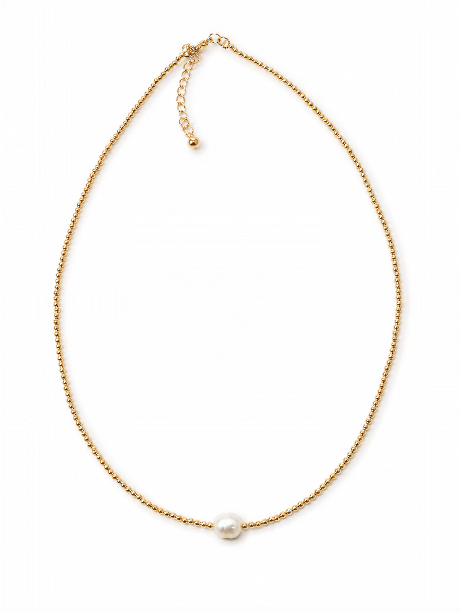 A delicate gold necklace with a single pearl pendant.