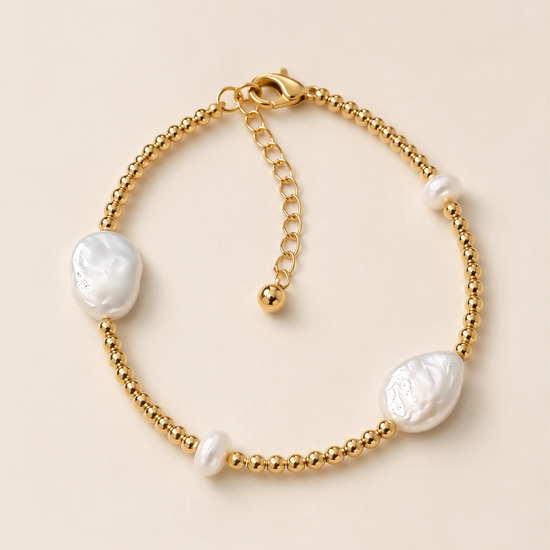 A gold-colored bracelet with pearl-like beads and a clasp.
