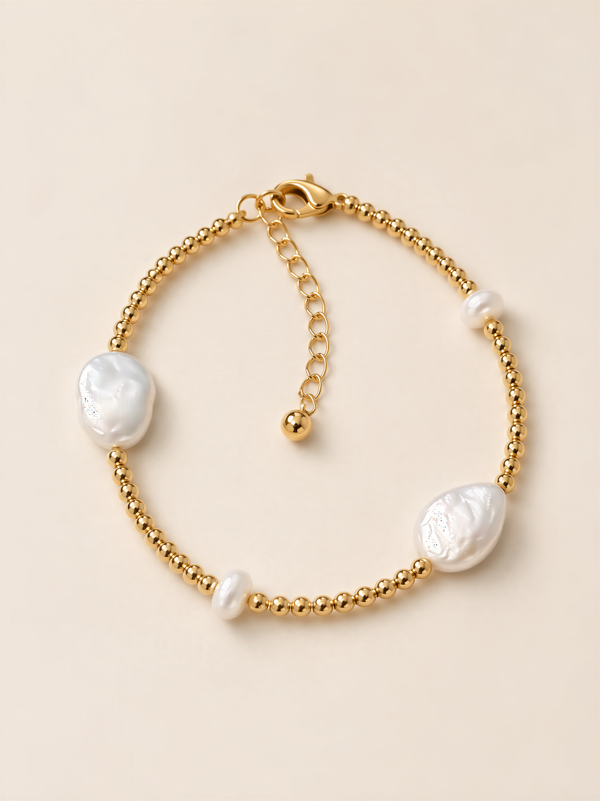 A gold-colored bracelet with pearl-like beads and a clasp.