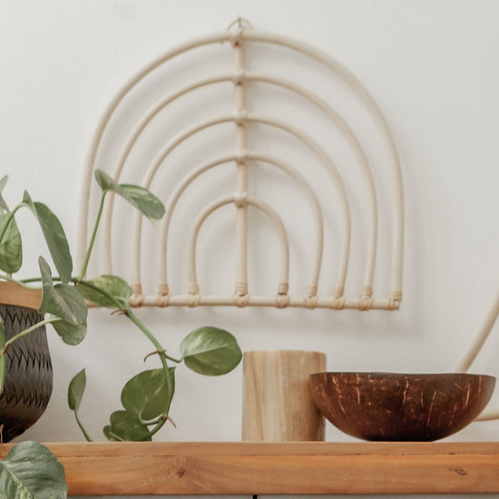 Rainbow Rattan Wall Decor handmade by Village Thrive using natural materials.