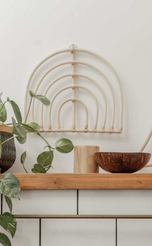 Rainbow Rattan Wall Decor handmade by Village Thrive using natural materials.