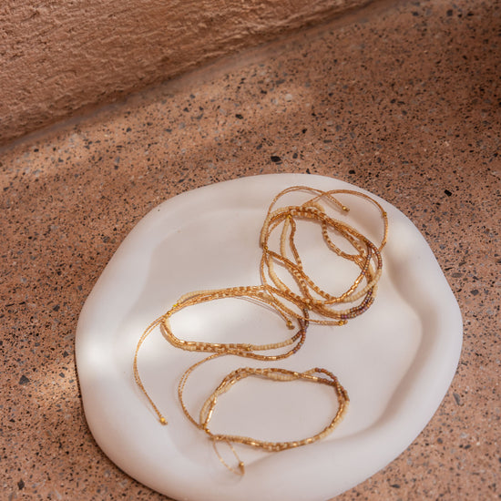 Stucco Cloud Round Tray handmade by Village Thrive using natural materials.