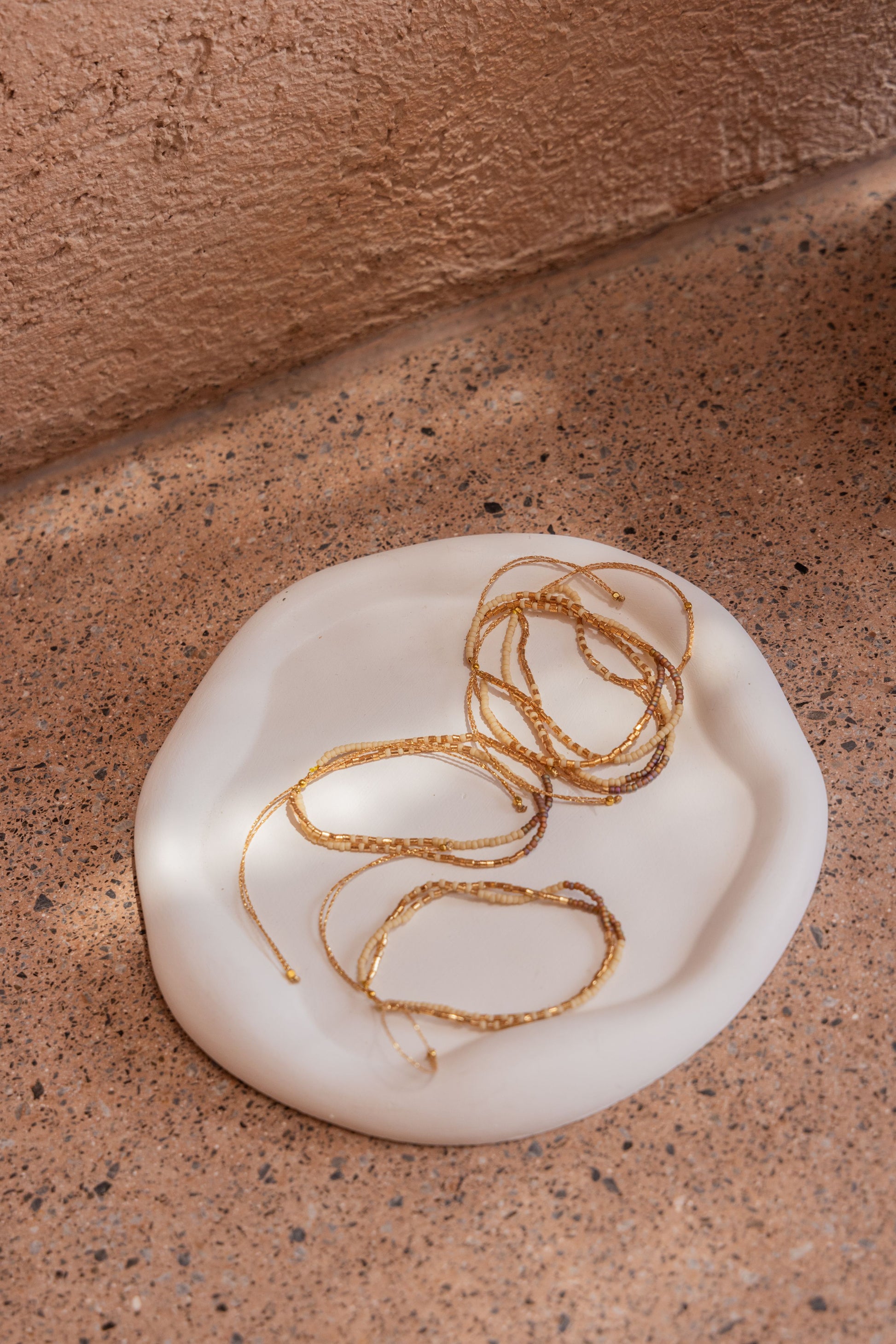 Stucco Cloud Round Tray handmade by Village Thrive using natural materials.