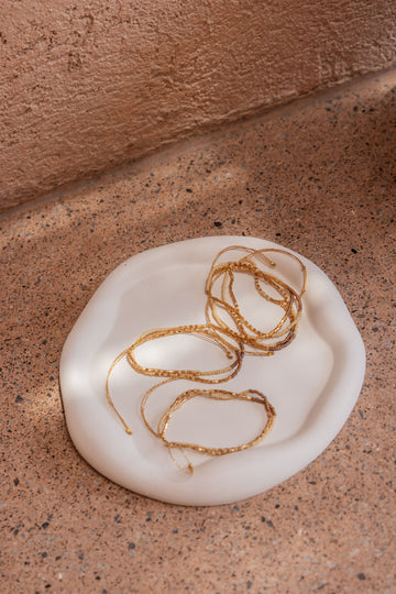 Stucco Cloud Round Tray handmade by Village Thrive using natural materials.