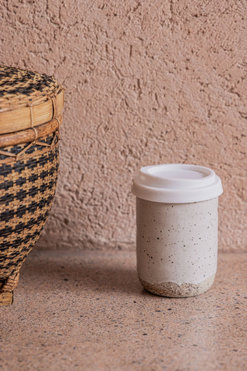 Wabi Ceramic To Go Mug handmade by Village Thrive using natural materials.