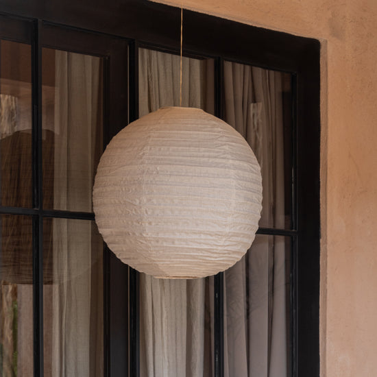 Linen Lantern Pendant handmade by Village Thrive using natural materials.