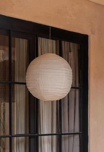 Linen Lantern Pendant handmade by Village Thrive using natural materials.