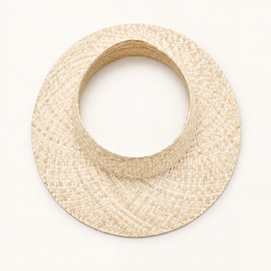 A straw hat with a round brim is shown against a plain white background.