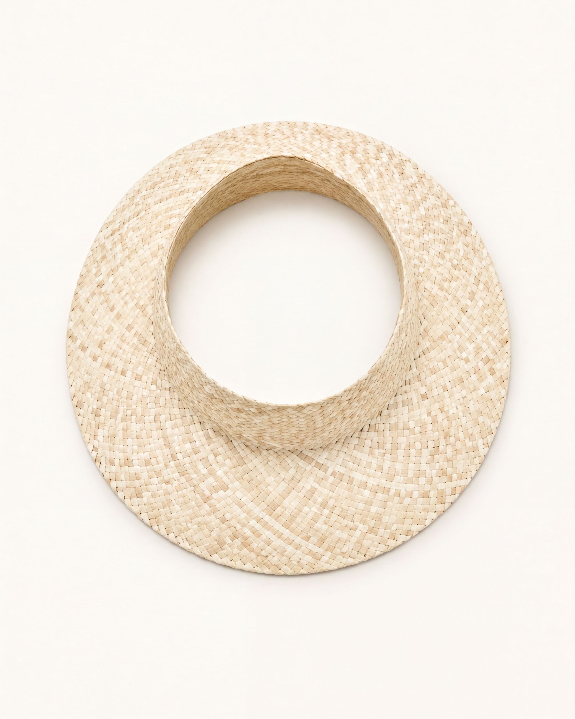 A straw hat with a round brim is shown against a plain white background.