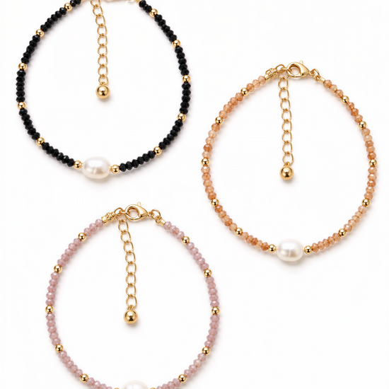 three beaded bracelets with pearls attached, each with a unique color and design.