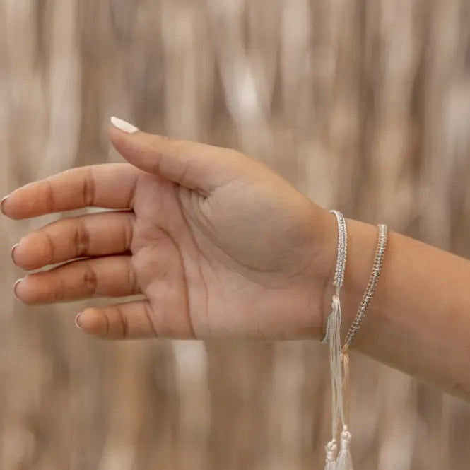 Silver Tassel Bracelets handmade by Village Thrive using natural materials.