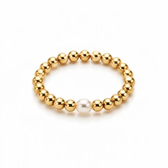 A gold-colored bracelet with a single pearl bead in the center.