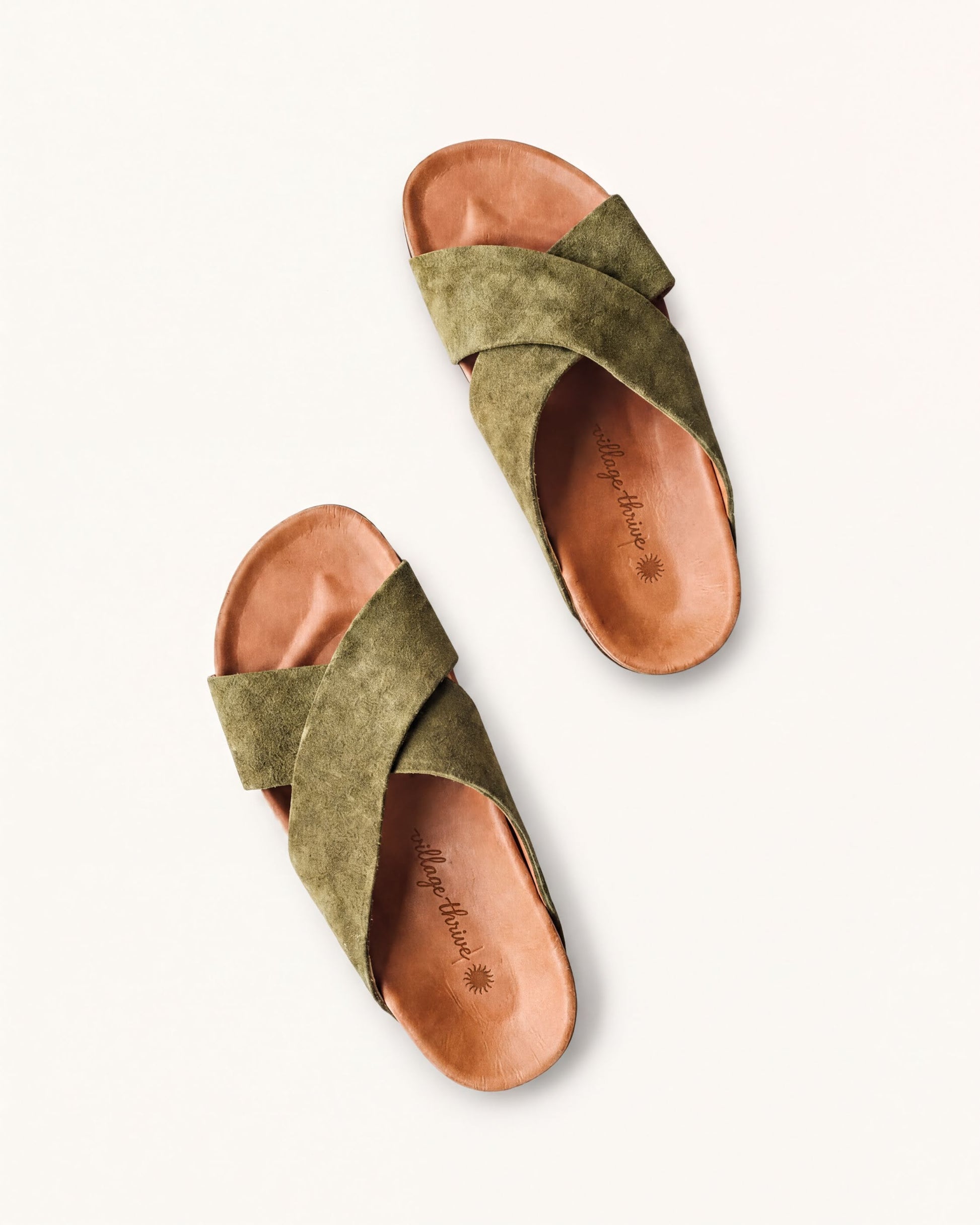 A pair of olive green sandals with a textured pattern and a strap across the top.