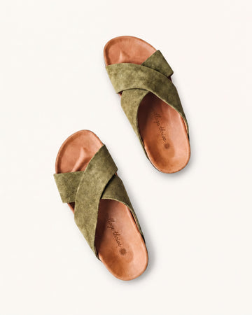 A pair of olive green sandals with a textured pattern and a strap across the top.
