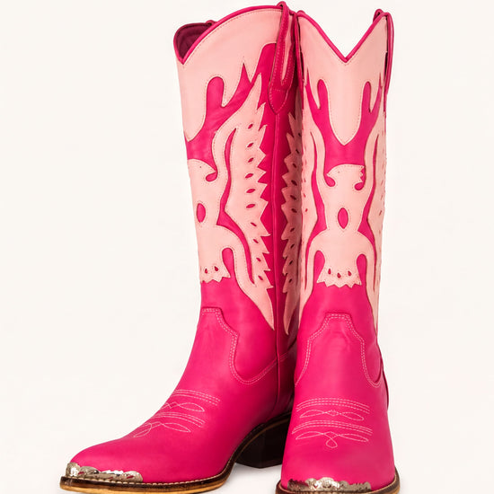 A pair of bright pink cowboy boots with a distinctive design on the sides.