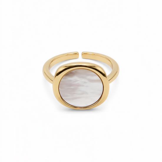A gold ring with a round oval-shaped stone in the center.