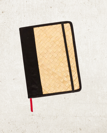 Cove Rattan & Leather Notebook handmade by Village Thrive using natural materials.
