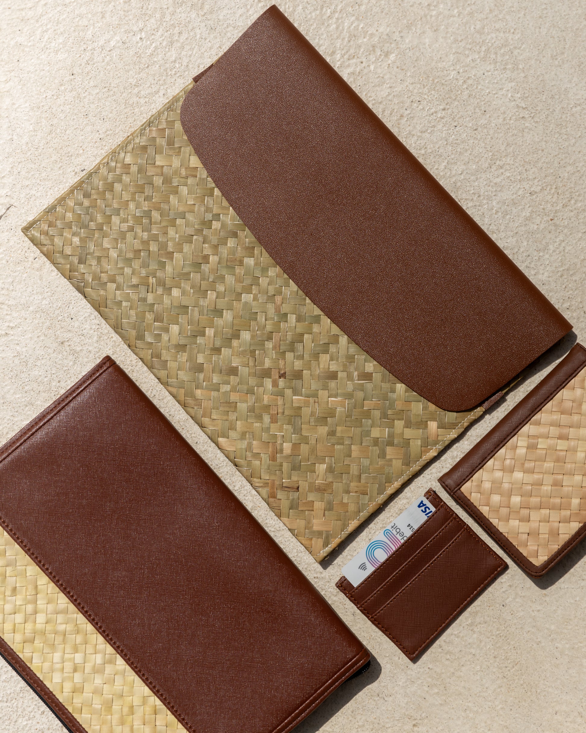 Cove Rattan & Leather Document Sleeve handmade by Village Thrive using natural materials.