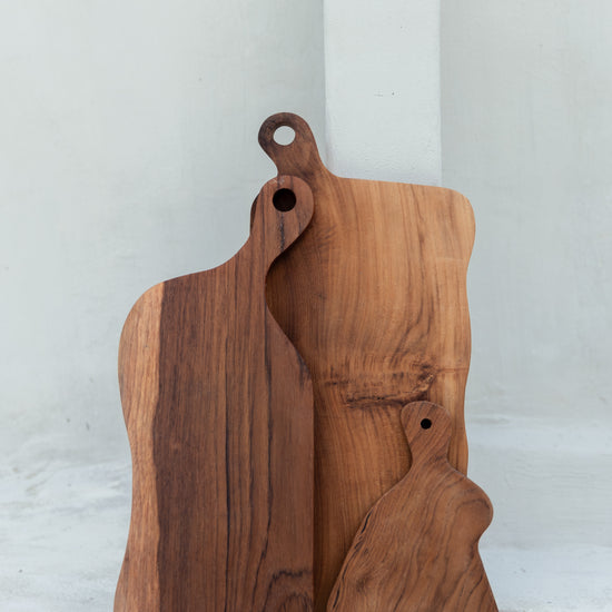 Teak Wavy Charcuterie Boards handmade by Village Thrive using natural materials.