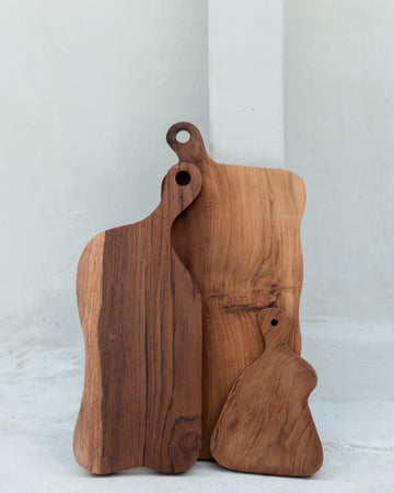 Teak Wavy Charcuterie Boards handmade by Village Thrive using natural materials.