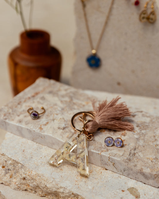 Wildflower Letter Keychain handmade by Village Thrive using natural materials.