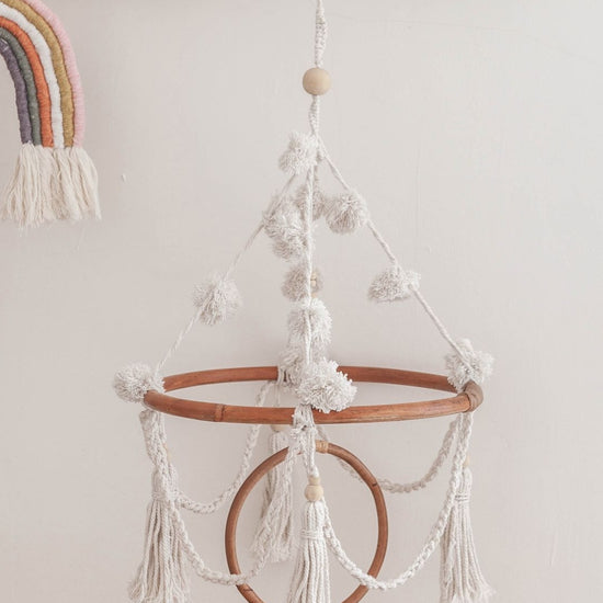 Pom Pom Baby Mobile handmade by Village Thrive using natural materials.