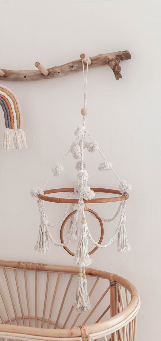 Pom Pom Baby Mobile handmade by Village Thrive using natural materials.