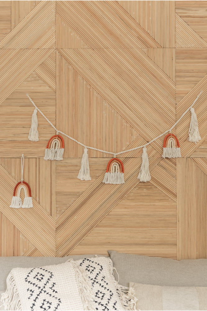 Rainbow Macrame Garland handmade by Village Thrive using natural materials.