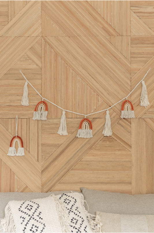 Rainbow Macrame Garland handmade by Village Thrive using natural materials.