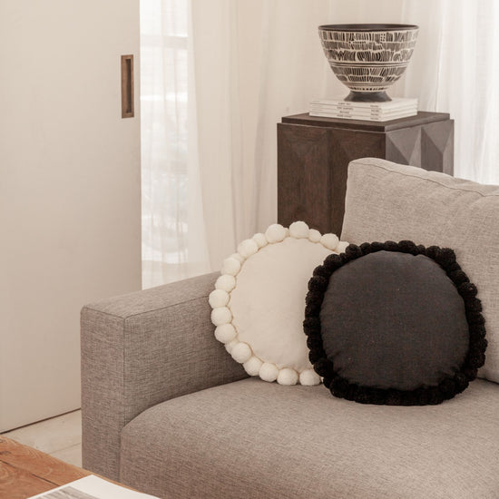 Round Pom Pom Pillow handmade by Village Thrive using natural materials.