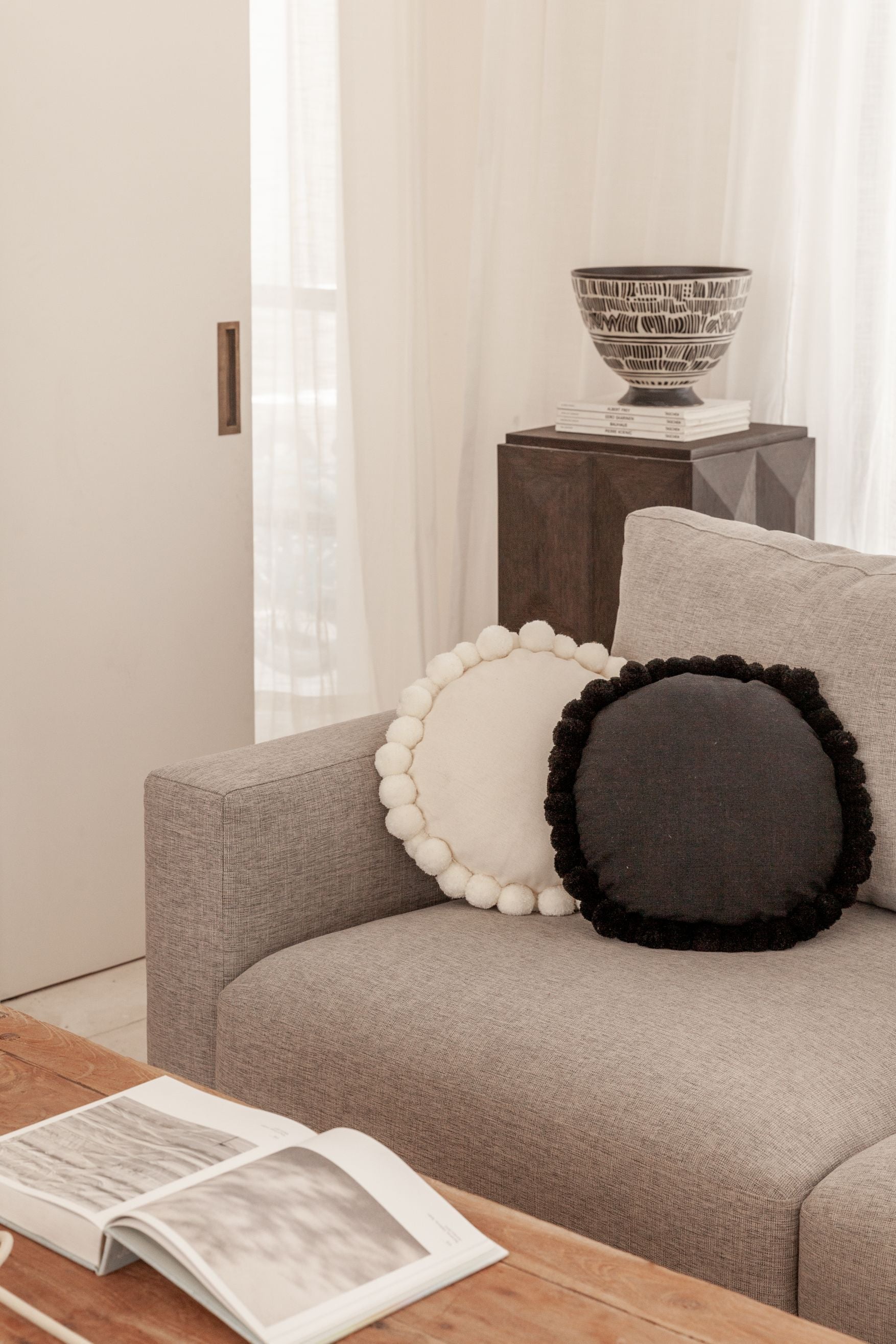 Round Pom Pom Pillow handmade by Village Thrive using natural materials.