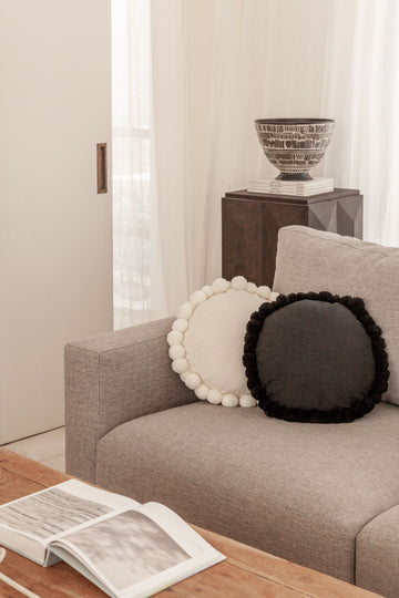 Round Pom Pom Pillow handmade by Village Thrive using natural materials.