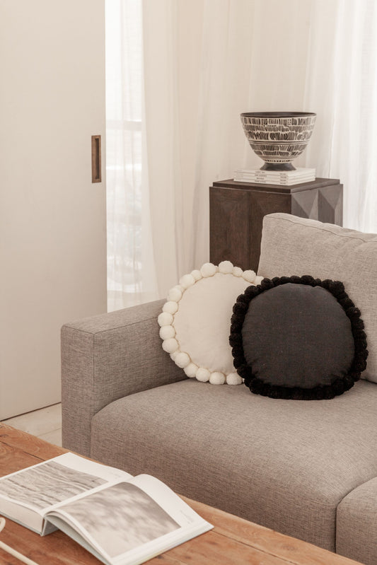 Round Pom Pom Pillow handmade by Village Thrive using natural materials.
