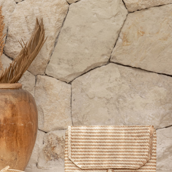 Stripes Rattan Clutch handmade by Village Thrive using natural materials.