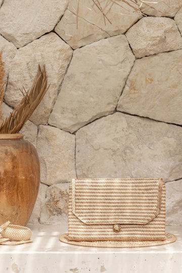 Stripes Rattan Clutch handmade by Village Thrive using natural materials.