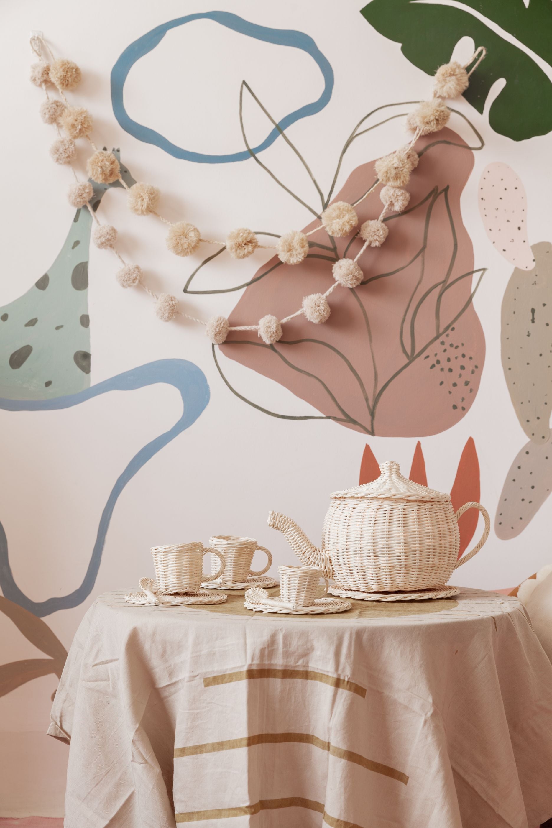 Pom Pom Raffia Garland handmade by Village Thrive using natural materials.