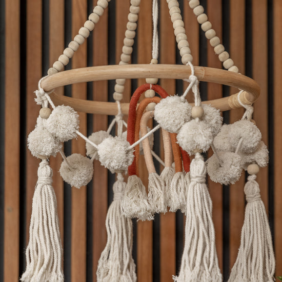 Rainbow Baby Mobile handmade by Village Thrive using natural materials.