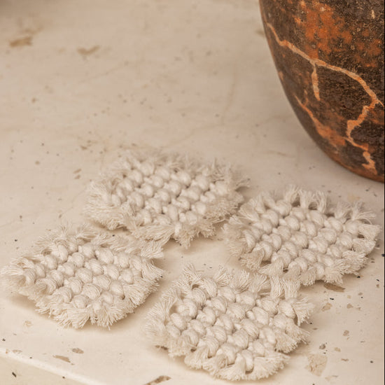 Knotted Macrame Coaster Set handmade by Village Thrive using natural materials.